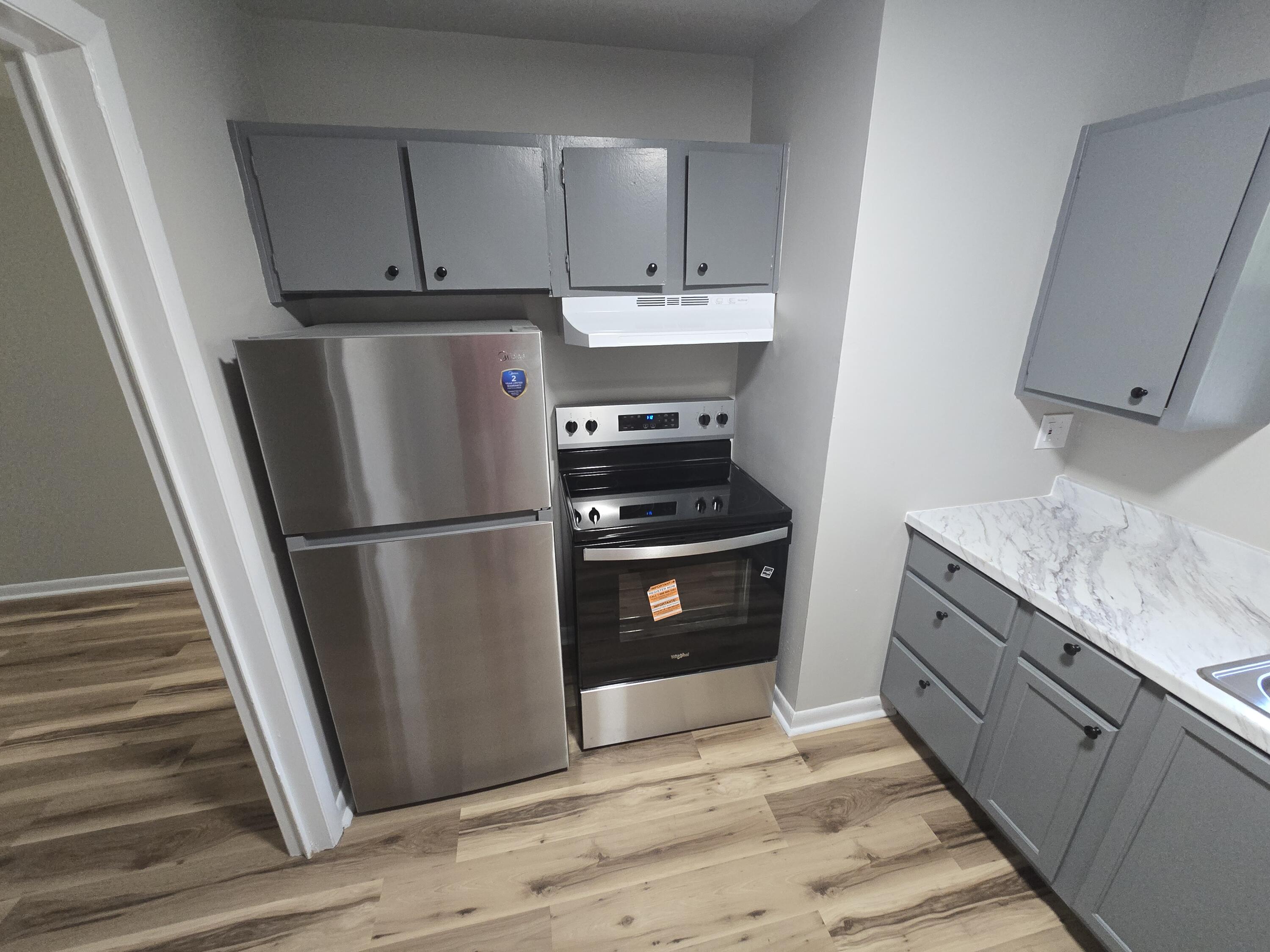 2607 Westover Avenue Southwest, Unit 106 Roanoke, VA 24015 - Photo 4 of 7 a kitchen with a refrigerator sink and cabinets