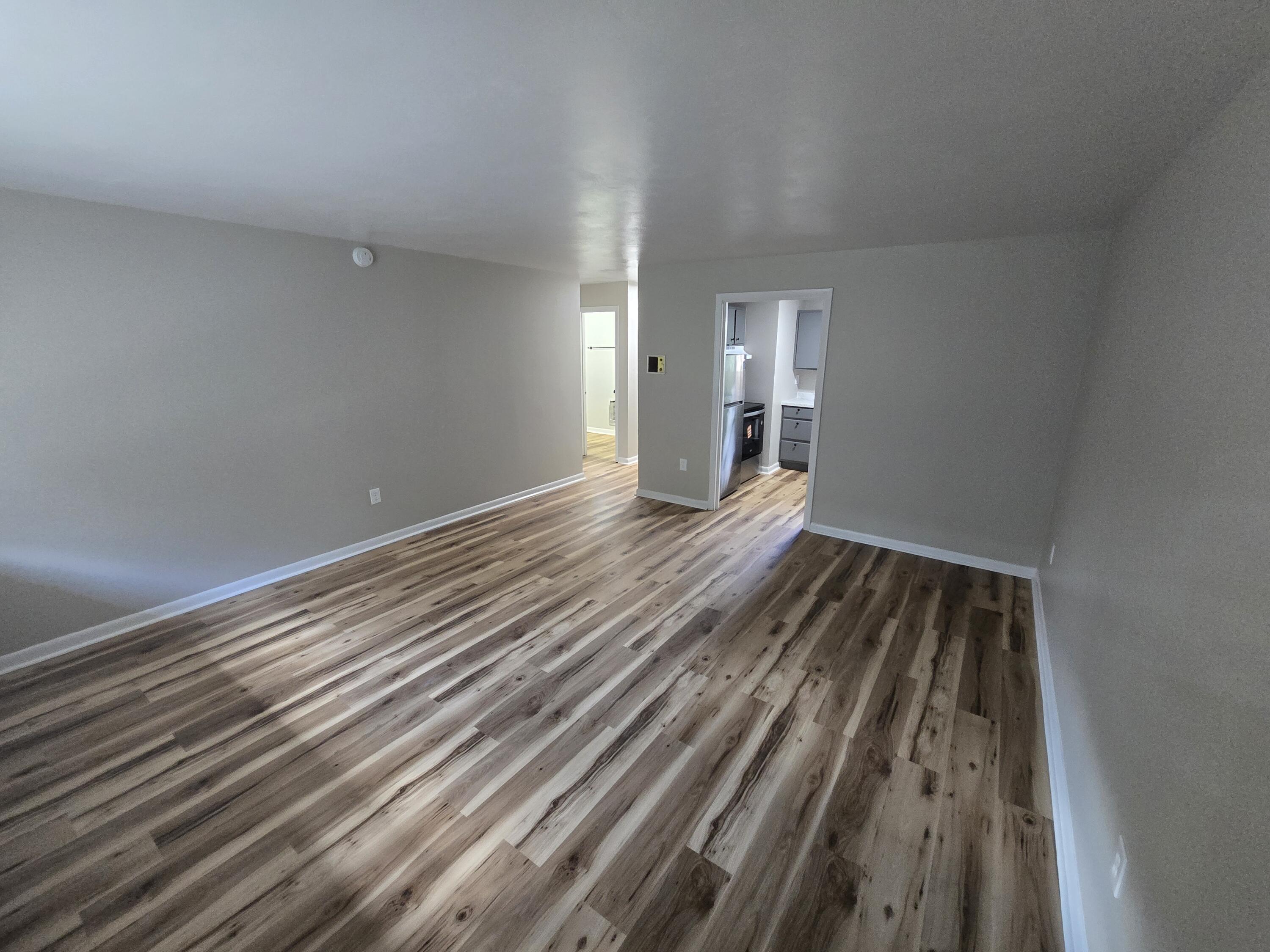 2607 Westover Avenue Southwest, Unit 106 Roanoke, VA 24015 - Photo 5 of 7 a view of an empty room with wooden floor and a window