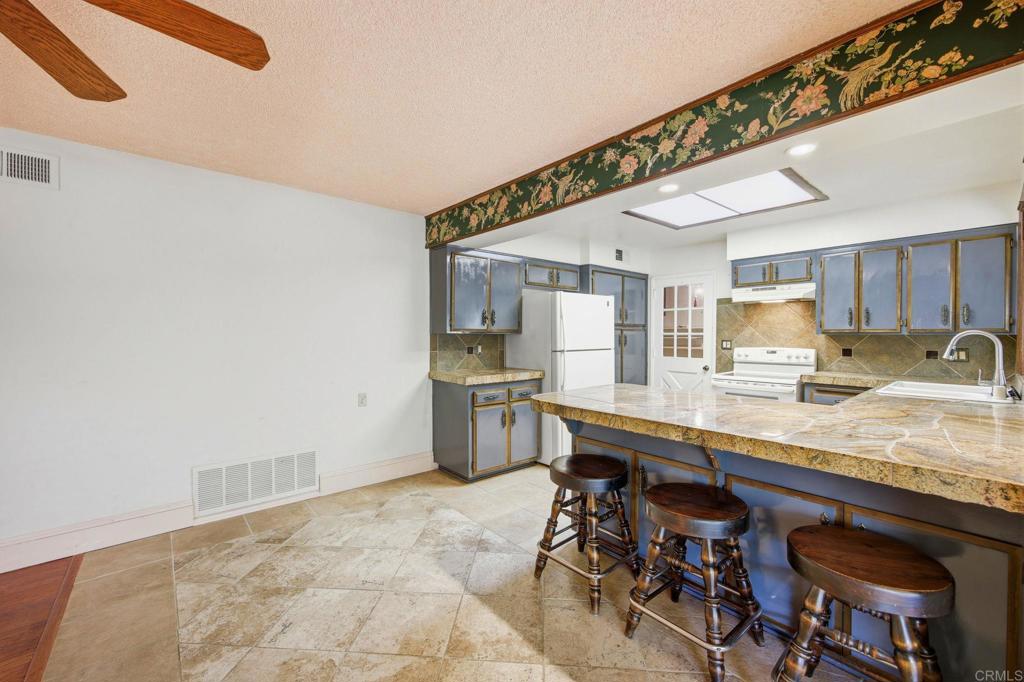 2807 South Grade Road Alpine, CA 91901 - Photo 12 of 42 a kitchen with stainless steel appliances granite countertop a sink a stove and a refrigerator
