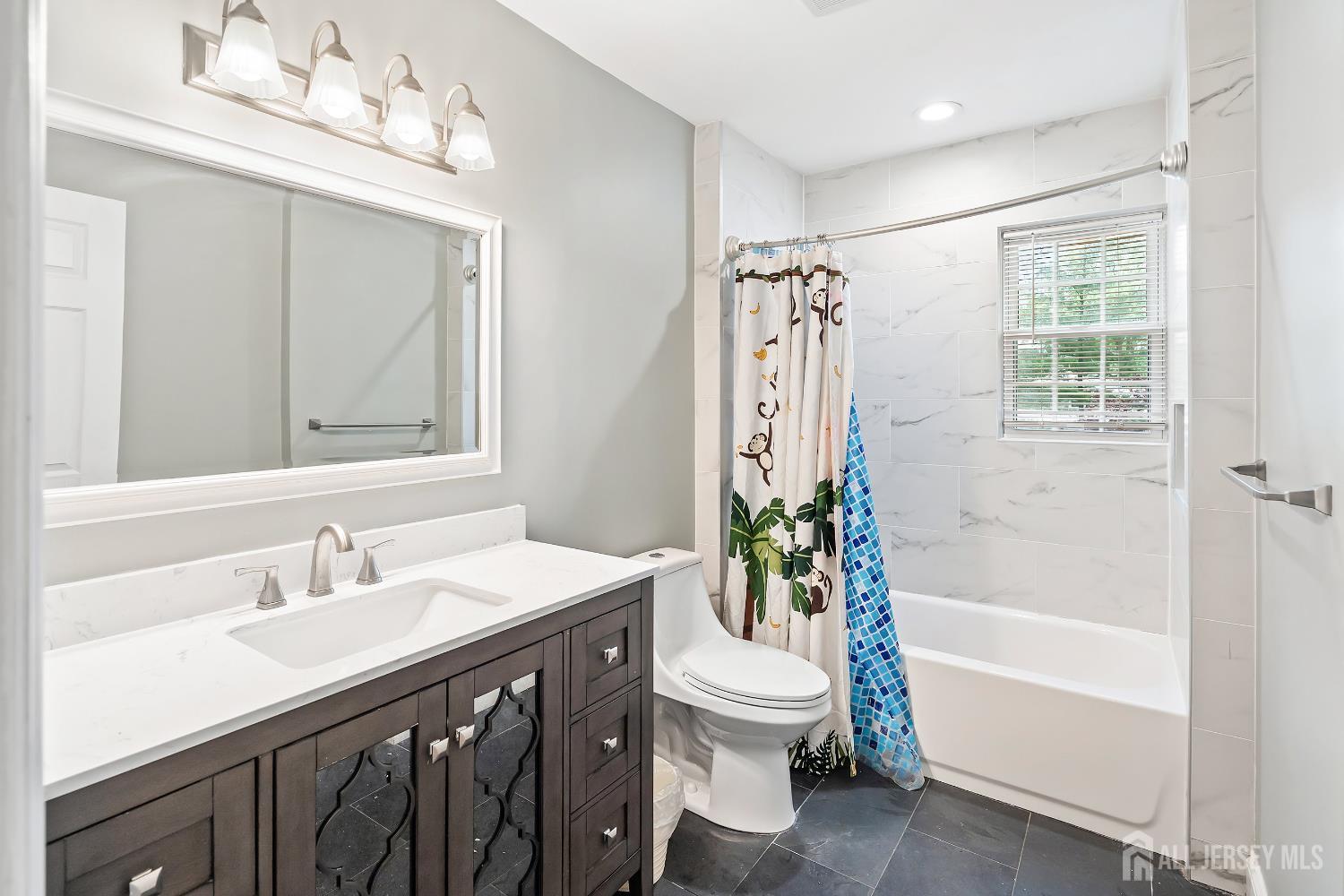 10 Woodruff Road Edison, NJ 08820 - Photo 8 of 18 a bathroom with a sink a toilet and shower