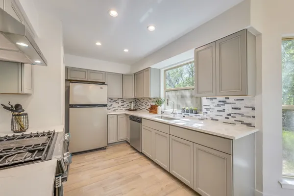 a kitchen with a sink stove and refrigerator