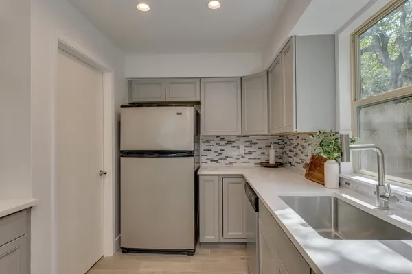 a kitchen with a refrigerator sink and stove