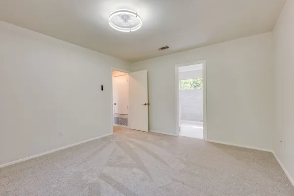 an empty room with windows and closet