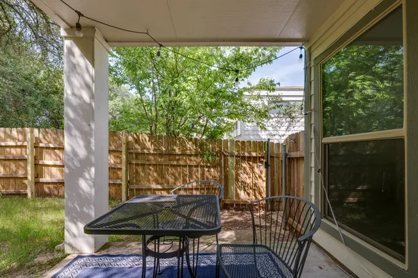 a view of balcony with a table and chairs