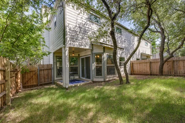 a view of a house with backyard porch and sitting area