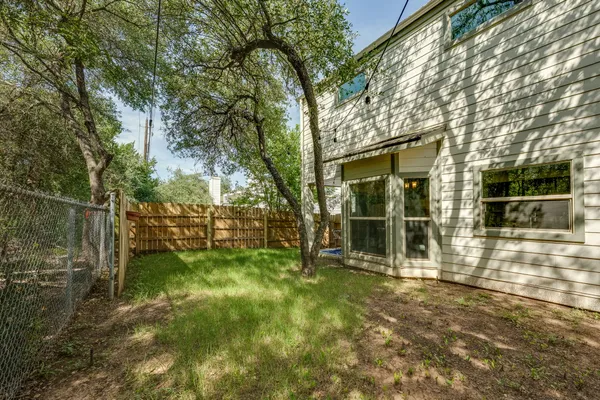 a view of a backyard with large trees