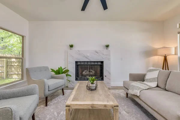 a living room with furniture and a fireplace