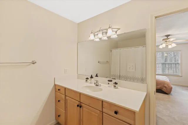 a en suite bathroom with a double vanity sink and a mirror