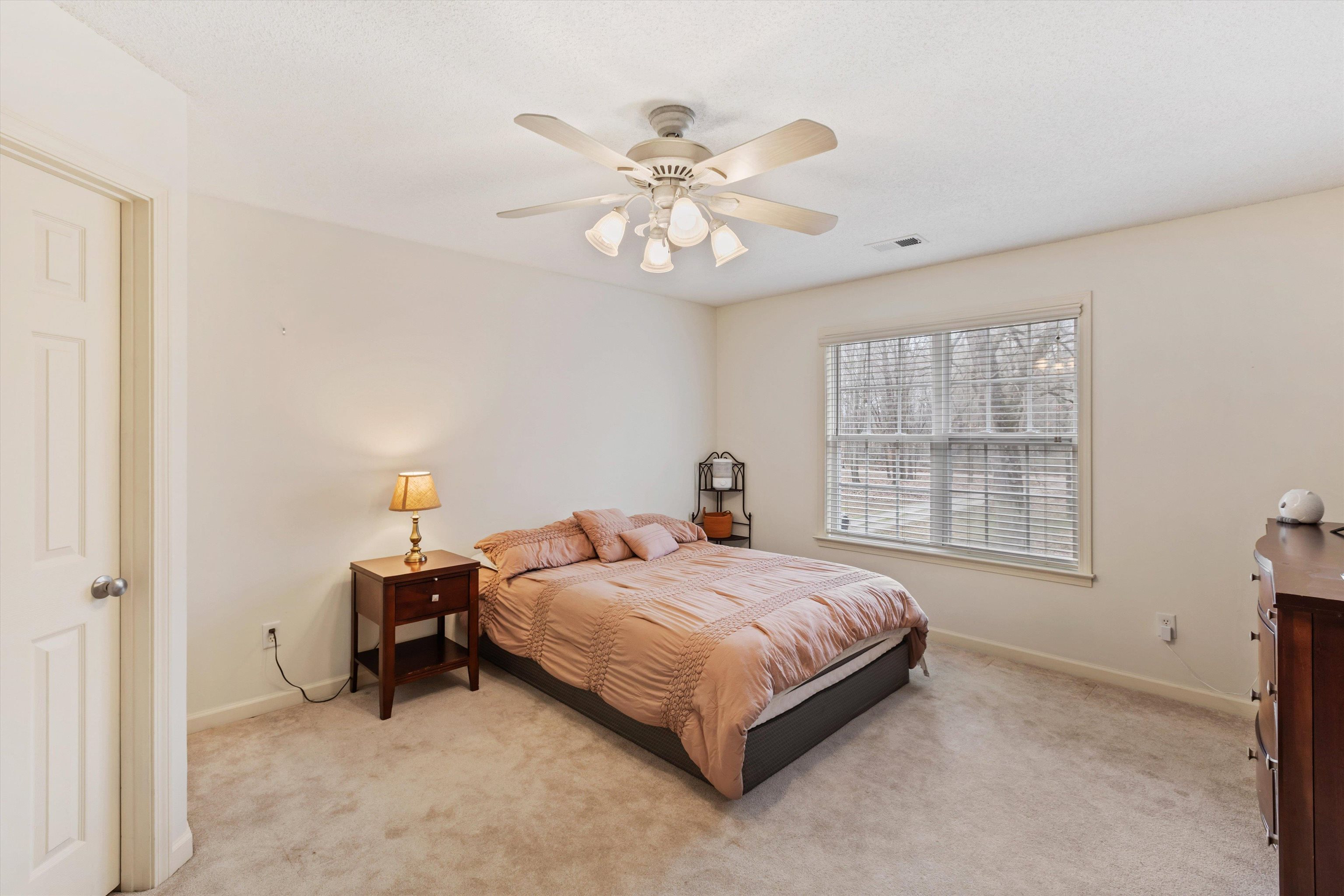 2789 North Collierville Arlington Road Eads, TN 38028 - Photo 21 of 34 a bedroom with a bed and a chandelier