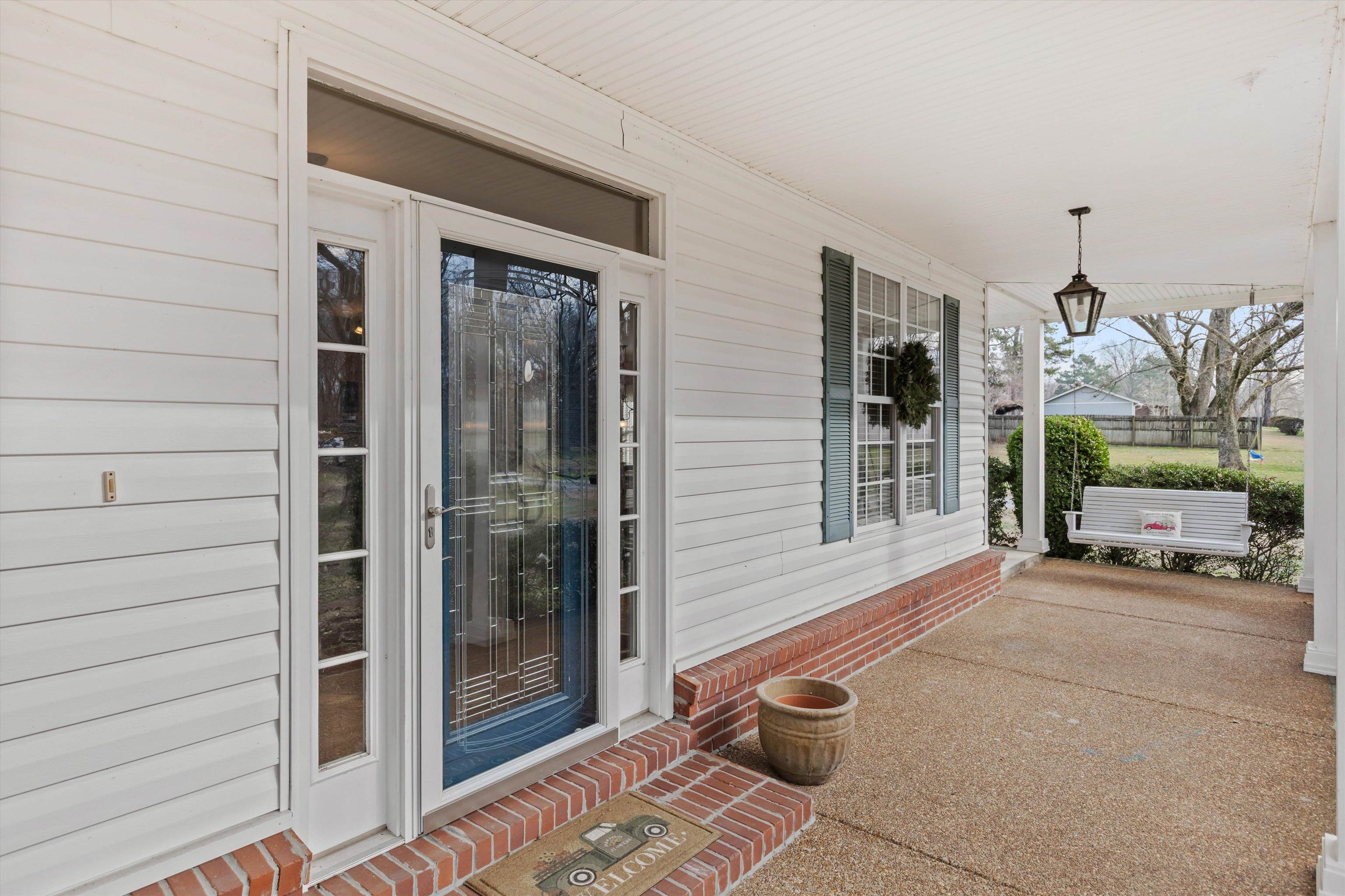 2789 North Collierville Arlington Road Eads, TN 38028 - Photo 4 of 34 a view of a porch with a table and chairs and potted plants