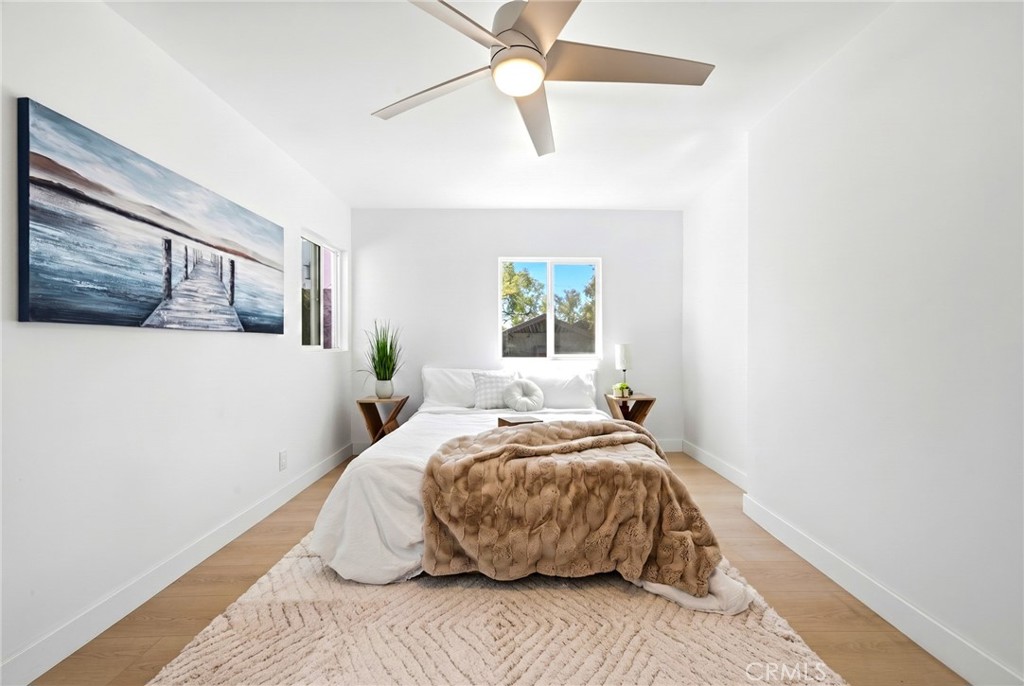 1280 East Woodbury Road Pasadena, CA 91104 - Photo 25 of 40 a bedroom with a bed and wooden floor