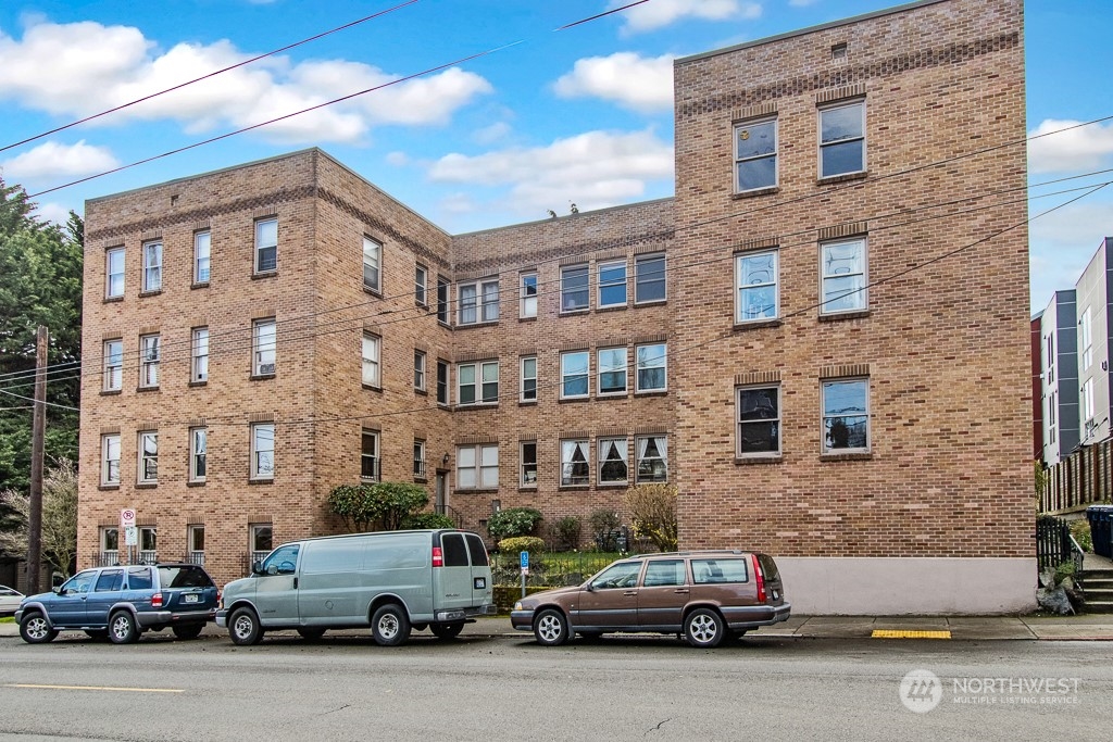 1427 3rd Avenue West, Unit 9 Seattle, WA 98119 - Photo 1 of 20 a car parked in front of a building