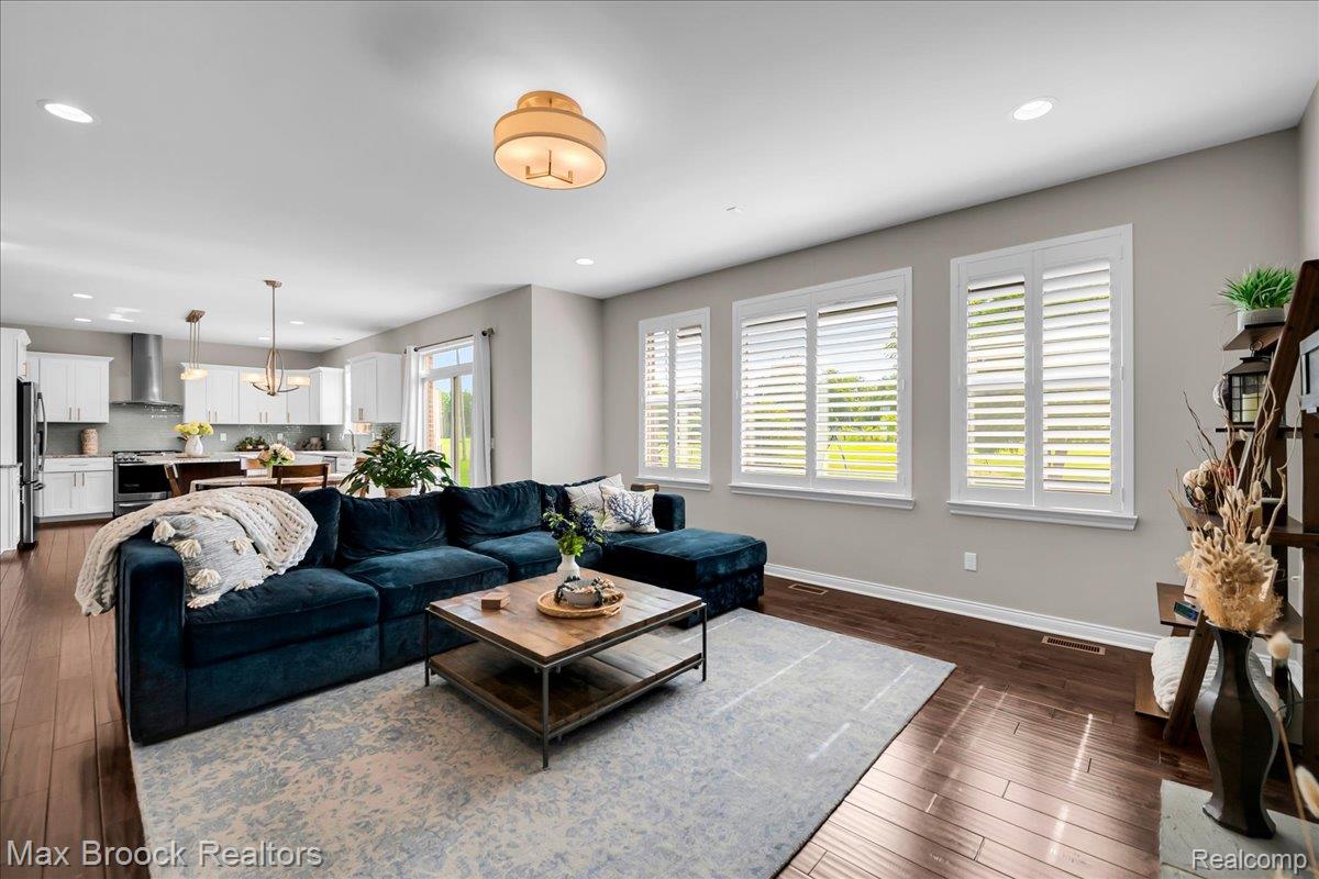 1126 Queensboro Drive Rochester, MI 48307 - Photo 12 of 66 Open-concept living area featuring rich wood-finish flooring, recessed lighting, and a modern ceiling fixture