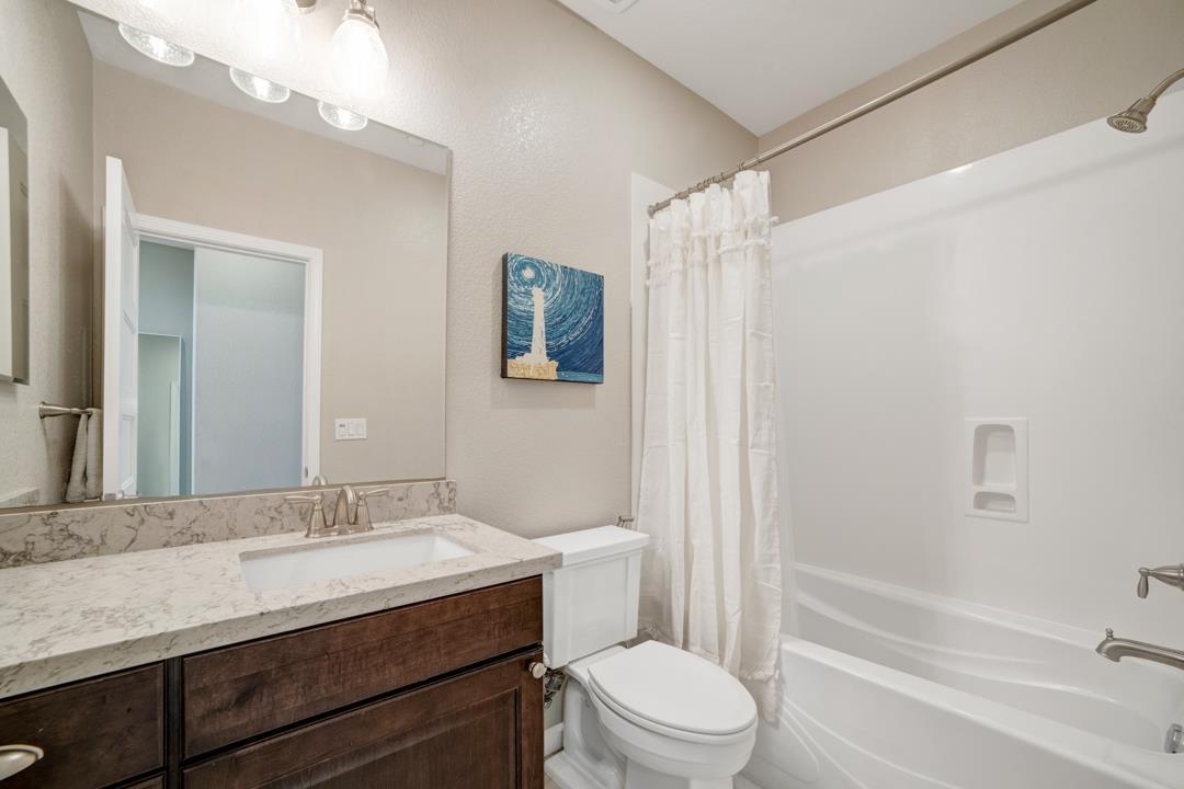 611 Clover Circle Milpitas, CA 95035 - Photo 26 of 30 a bathroom with a granite countertop sink toilet and shower