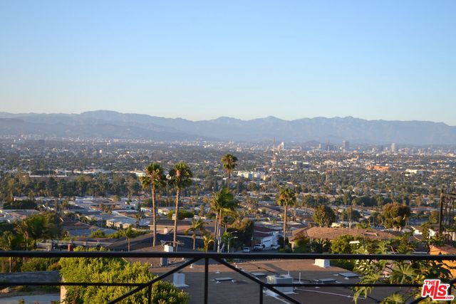 a kitchen with kitchen island a sink stove and chairs