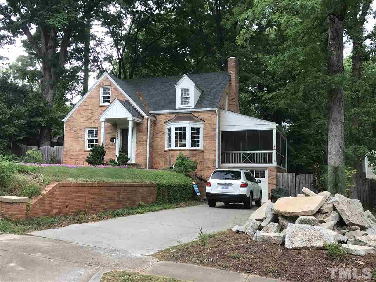 3212 Ruffin Street Raleigh, NC 27607 - Photo 1 of 3 a car parked in front of a house with a yard