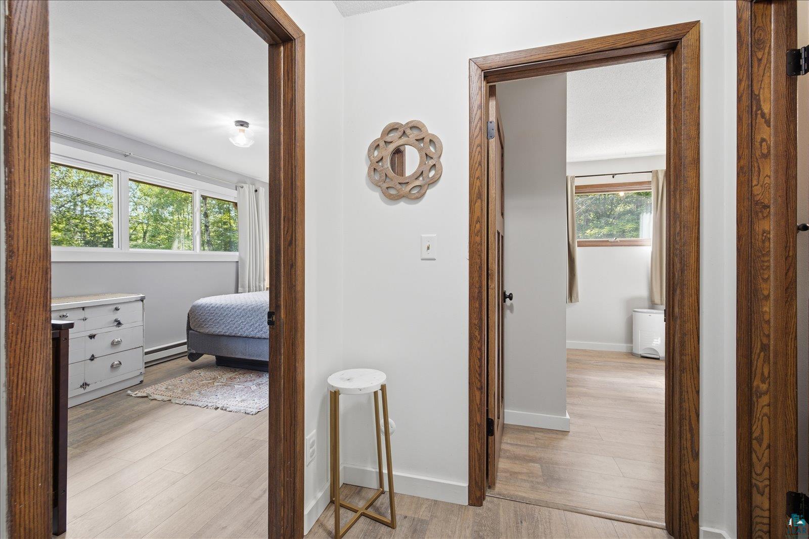 6377 Bergstrom Road Saginaw, MN 55779 - Photo 12 of 20 Hallway with light wood-finish flooring, white walls, and dark wood door frames
