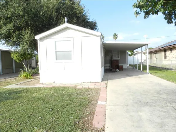 a view of a house with a yard and garage
