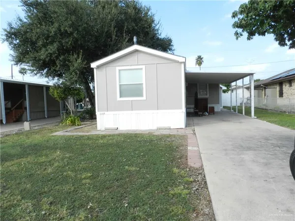 a view of a house with a yard and garage