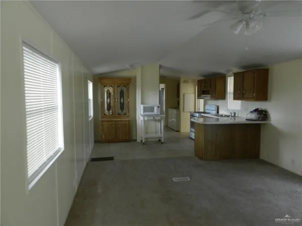 a kitchen with refrigerator and cabinets