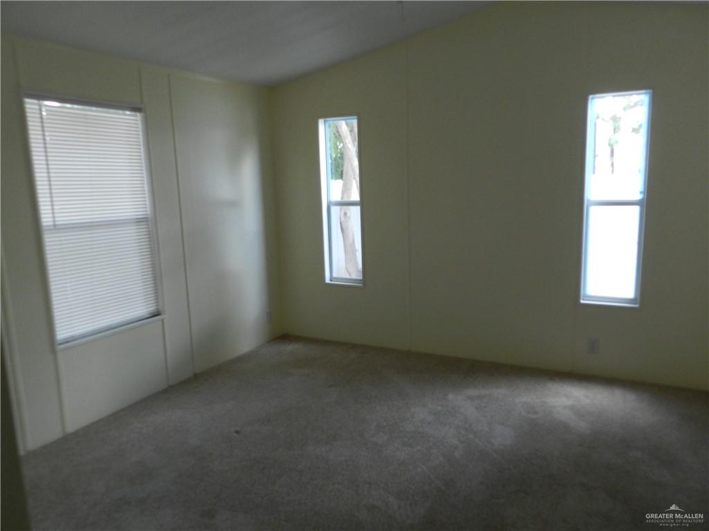 2113 Amy Street Mission, TX 78572 - Photo 4 of 17 an empty room with windows and closet