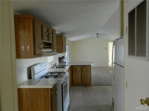 a kitchen with stainless steel appliances granite countertop a stove and a refrigerator