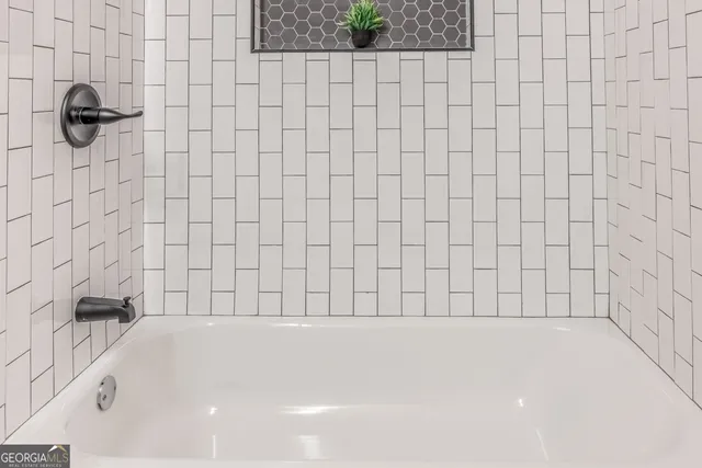 a bathroom with a bathtub and shower