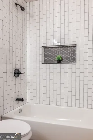 an empty room with a window and wooden floor