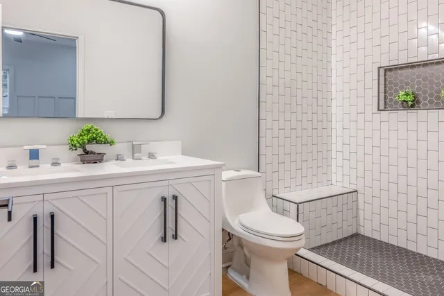 a bathroom with a sink vanity and mirror