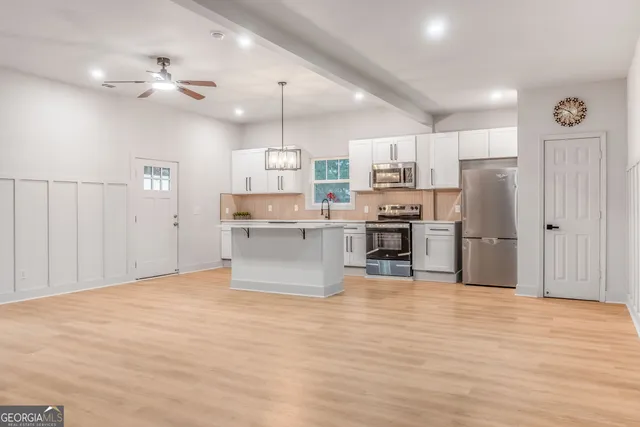 a kitchen with stainless steel appliances a sink and a refrigerator