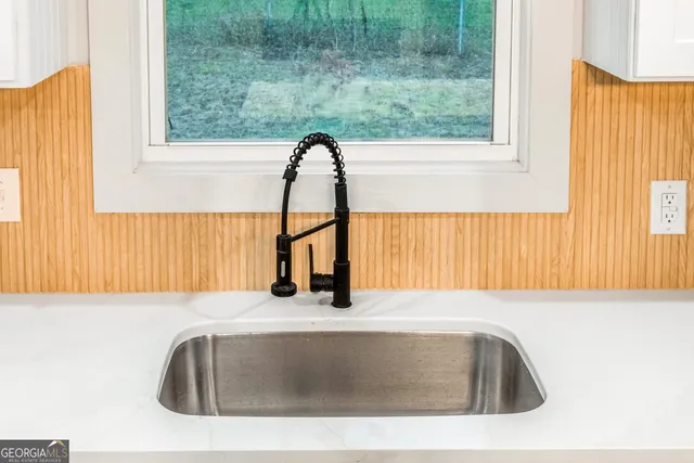 a kitchen with stainless steel appliances granite countertop a sink and a stove top oven