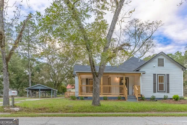 a front view of a house with a yard