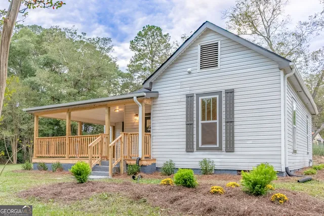 a front view of a house with garden