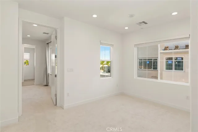 an empty room with windows and closet