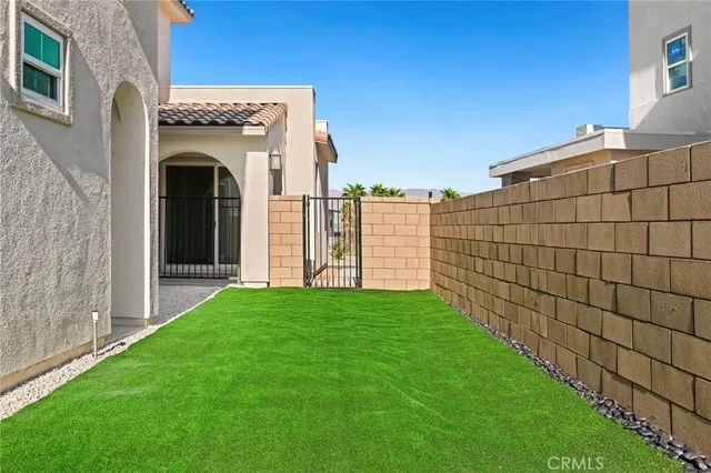 a view of an entrance to house with yard