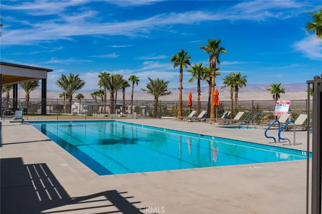 a view of a swimming pool with outdoor seating