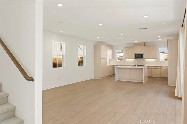 a view of kitchen with wooden floor and electronic appliances