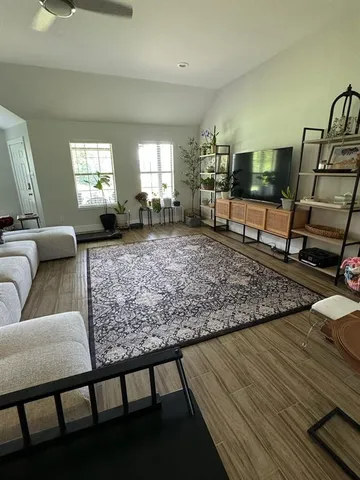 a living room with furniture and wooden floor