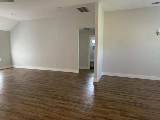 a view of a room with wooden floor