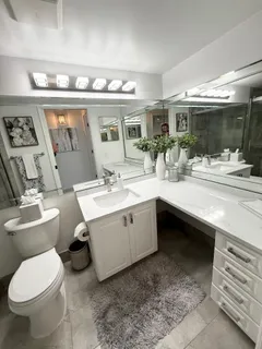 a bedroom with a bed window and lamp
