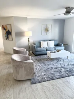 a living room with furniture and a lamp