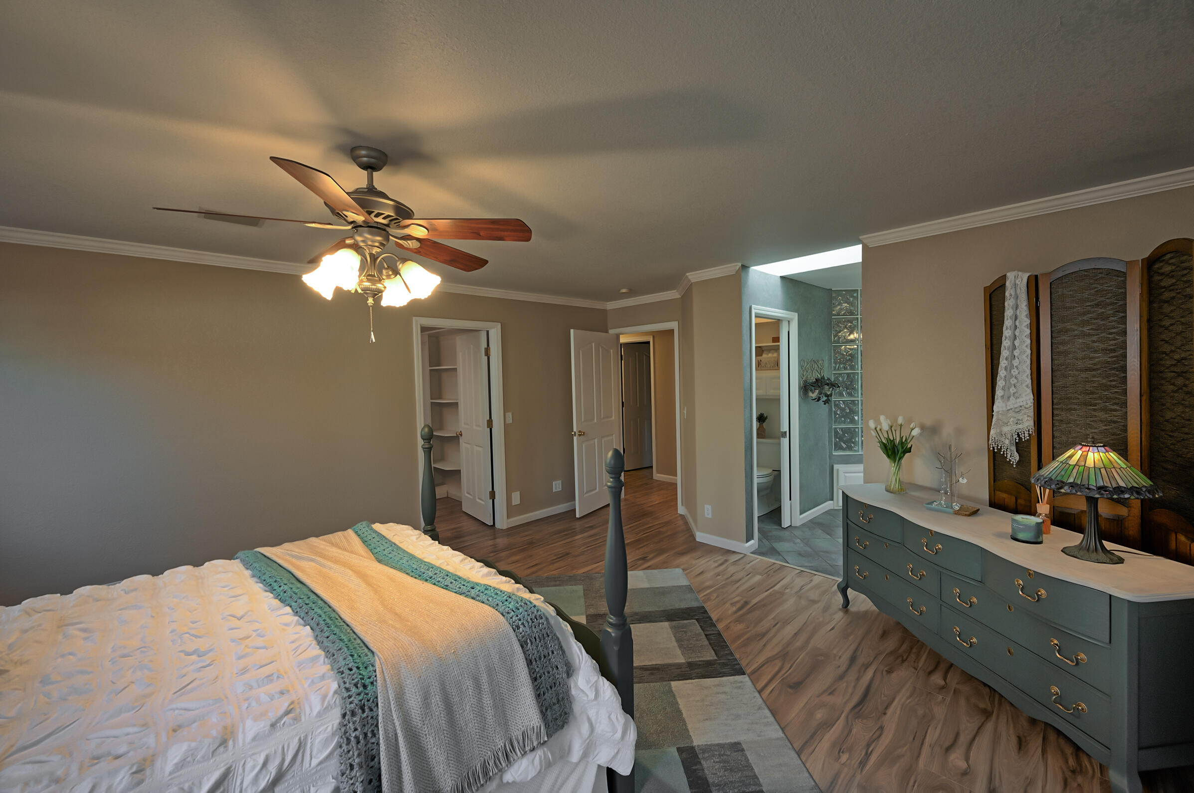 2885 Starlight Boulevard Redding, CA 96001 - Photo 16 of 51 a bedroom with a large bed and a chandelier