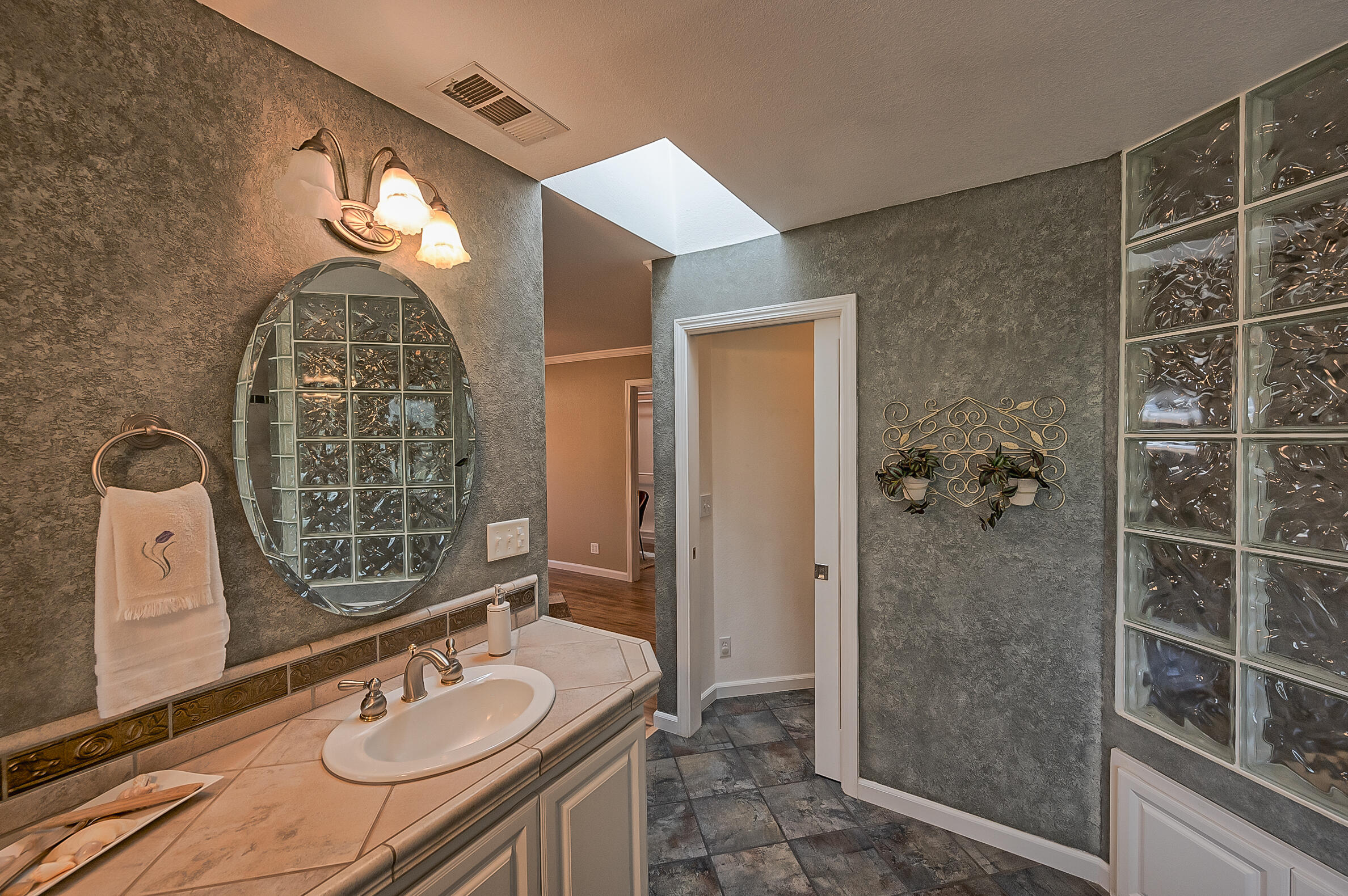 2885 Starlight Boulevard Redding, CA 96001 - Photo 21 of 51 a bathroom with a granite countertop sink a mirror and shower