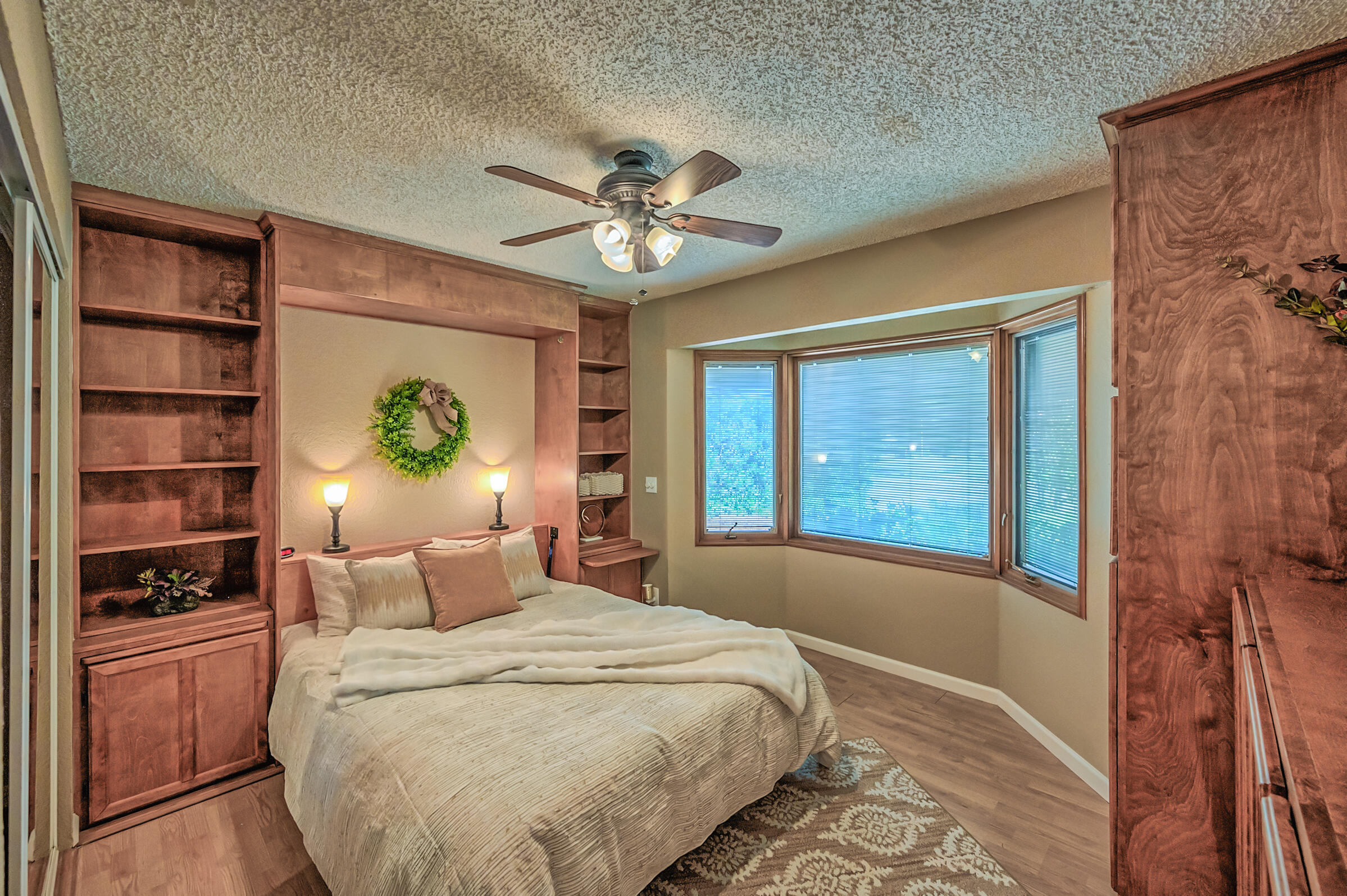 2885 Starlight Boulevard Redding, CA 96001 - Photo 27 of 51 a bedroom with a bed and dresser with wooden floor