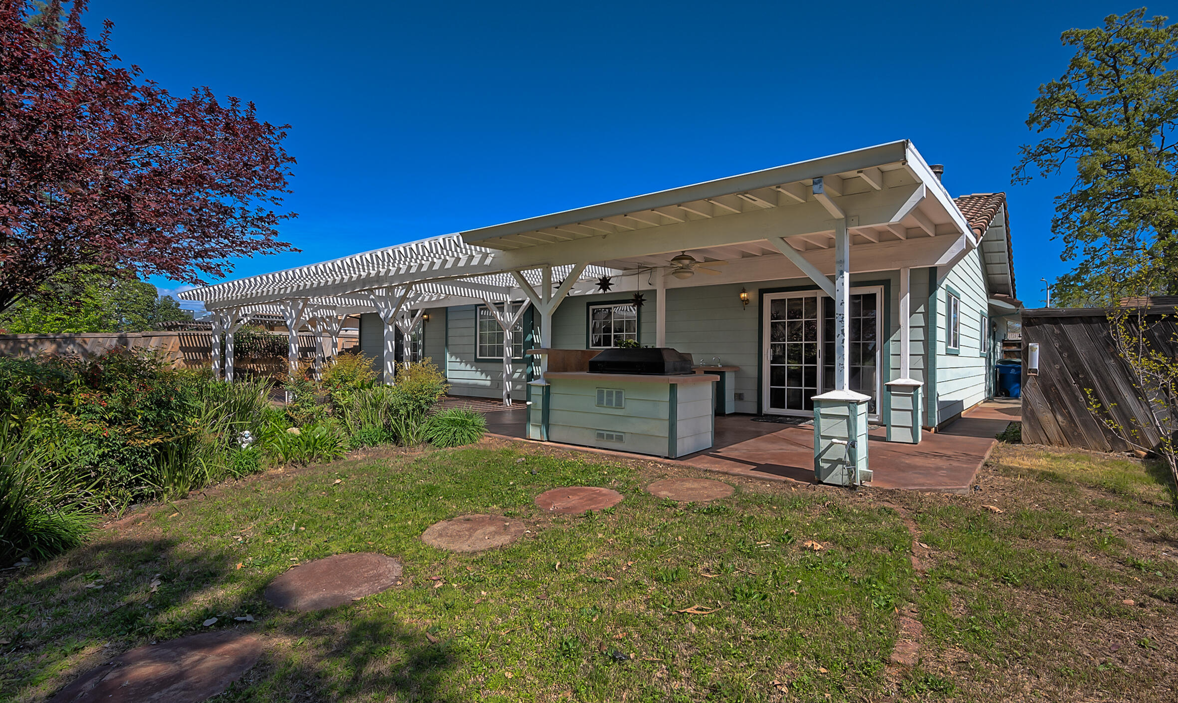 2885 Starlight Boulevard Redding, CA 96001 - Photo 43 of 51 a view of a house with backyard sitting area and garden