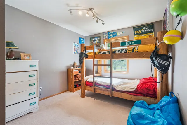 a bedroom with furniture and a fan