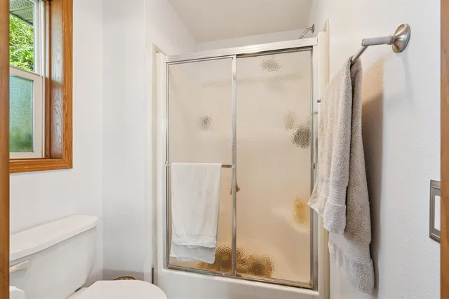 a bathroom with a glass shower door