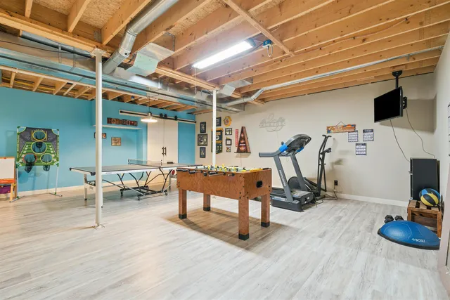 a room with gym equipment and a table