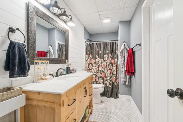 a bathroom with a sink vanity and a mirror