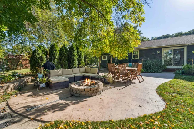 a view of a patio with dining table and chairs with a fire pit